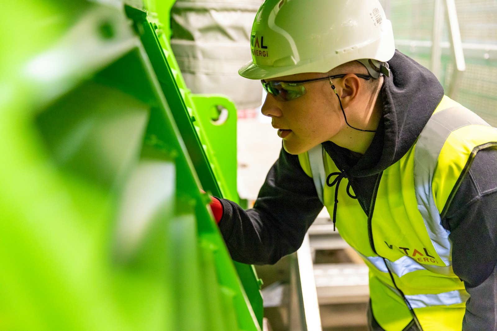Worker wearing a hard hat and protective equipment